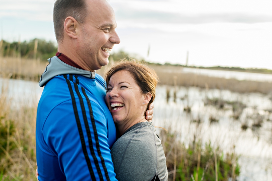 A fun engaged couple laugh on the beach during their Long Beach Island engagement session.